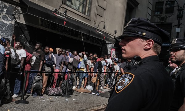 A police officer standing in front of a crowdAI-generated content may be incorrect.